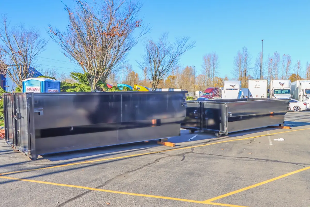 Professional dumpster rental service with roll-off container on residential driveway in Upper Allen